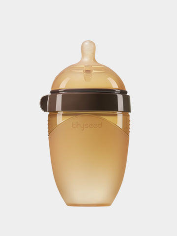 Thyseed 8oz silicone baby bottle in Thyseed Brown with a natural-looking nipple and brown collar.